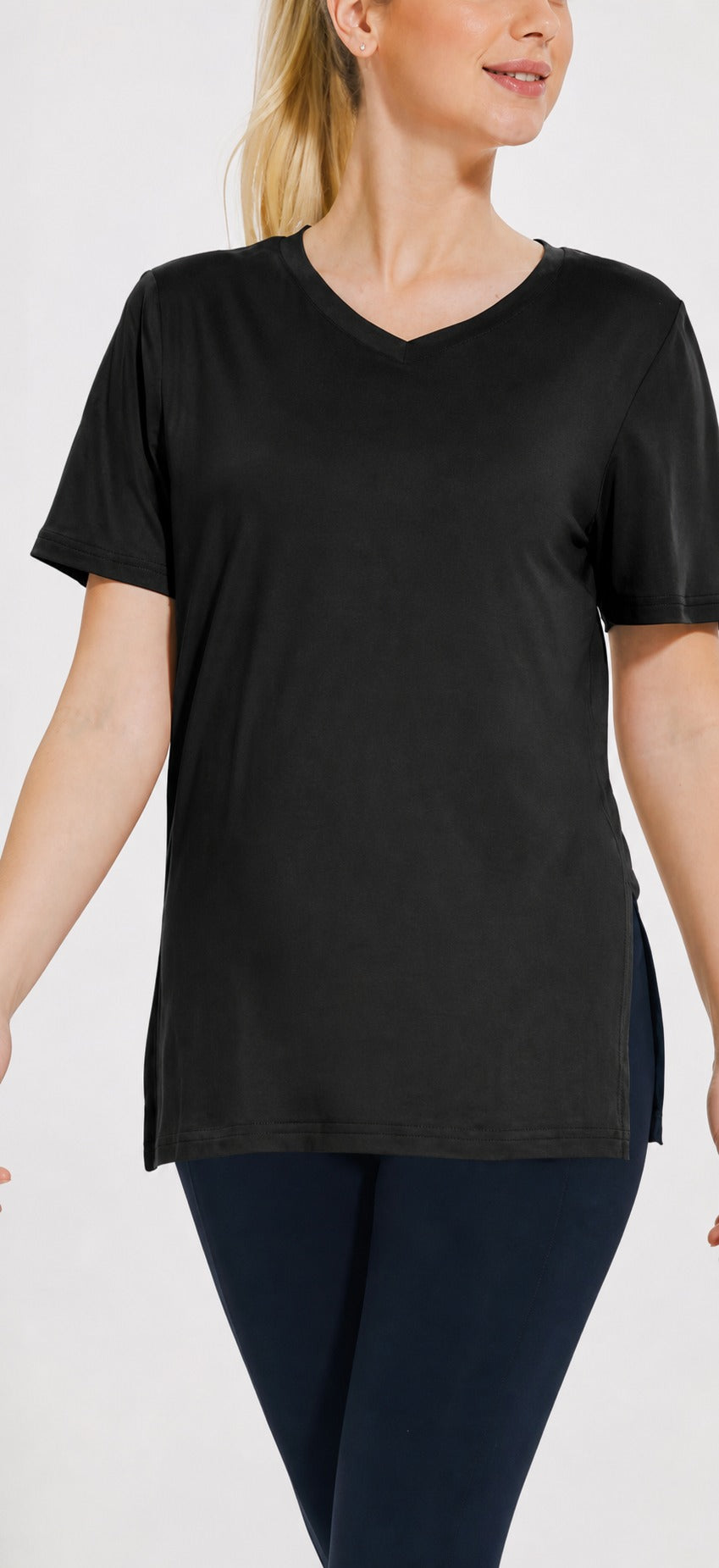 Woman wearing the black Selena loose-fit V-neck tee with side splits