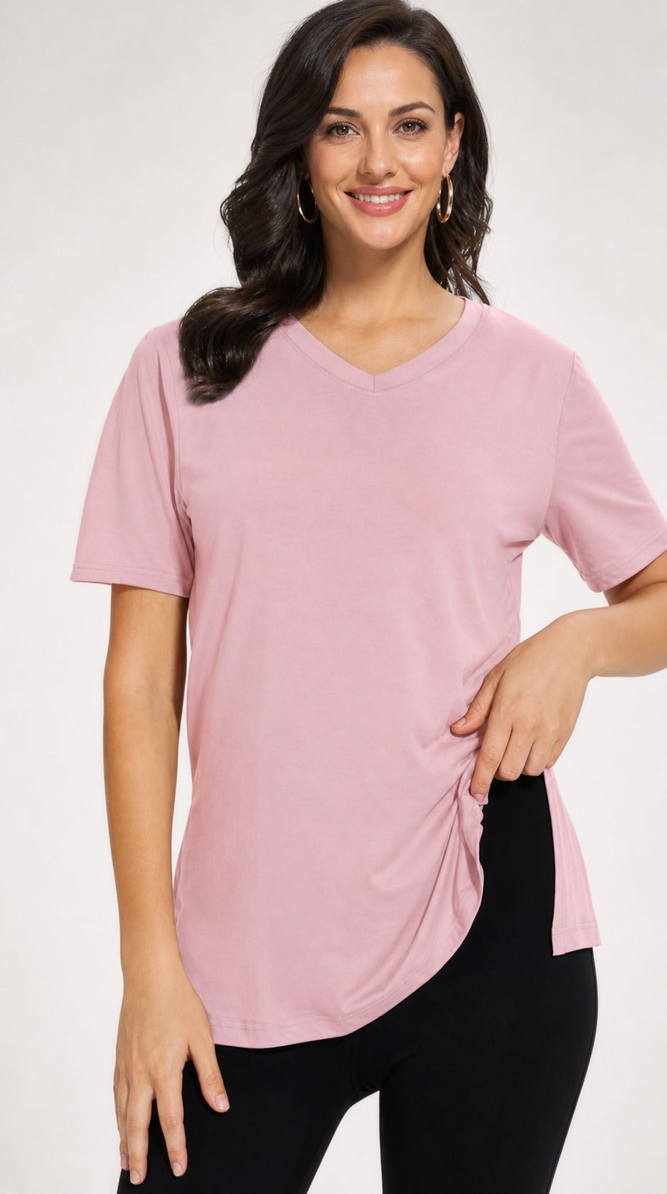 Woman wearing the dusty pink Selena loose-fit V-neck tee with side splits