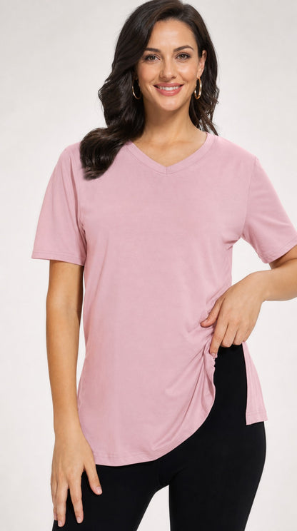 Woman wearing the dusty pink Selena loose-fit V-neck tee with side splits
