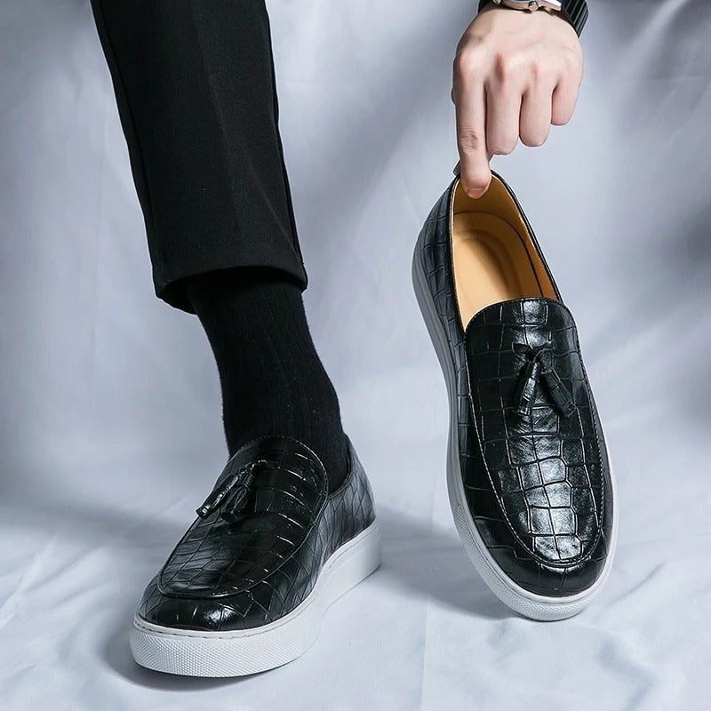 Vestralo Passero brown tassel loafer held in hand showing supple croc-embossed leather and hand-set tassel